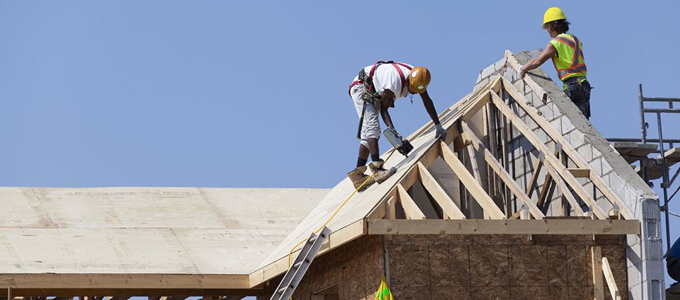 Roofers carry out work on a construction project