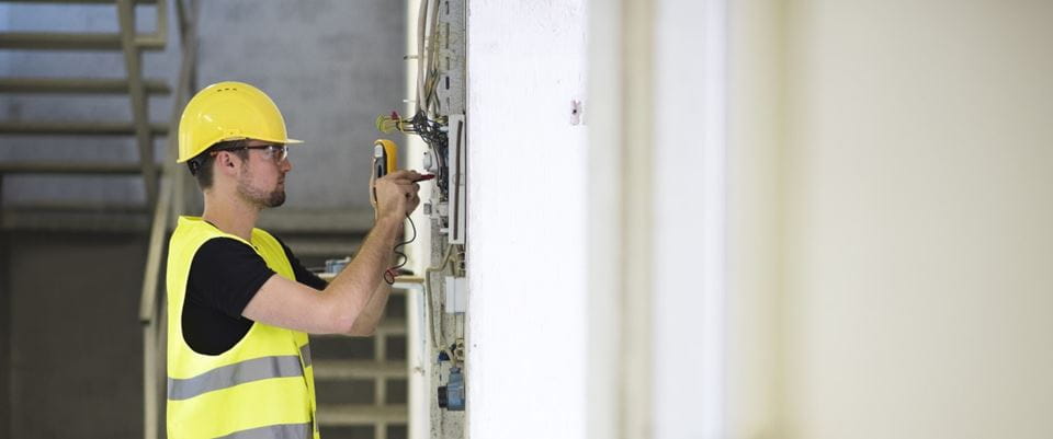 electrical contractor rewires a building