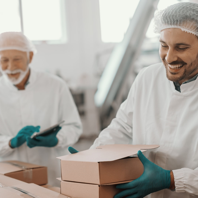 Two men packaging food